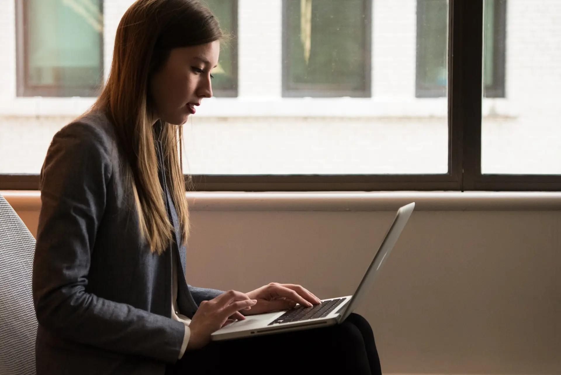 Business woman reviewing her Free Website Mockup